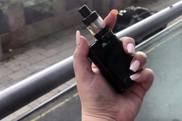 Hand holding an e-cigarette device — blu owner reference
