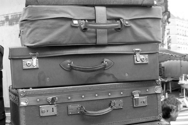 Stacked vintage suitcases — flying with rolling tobacco and RYO gear