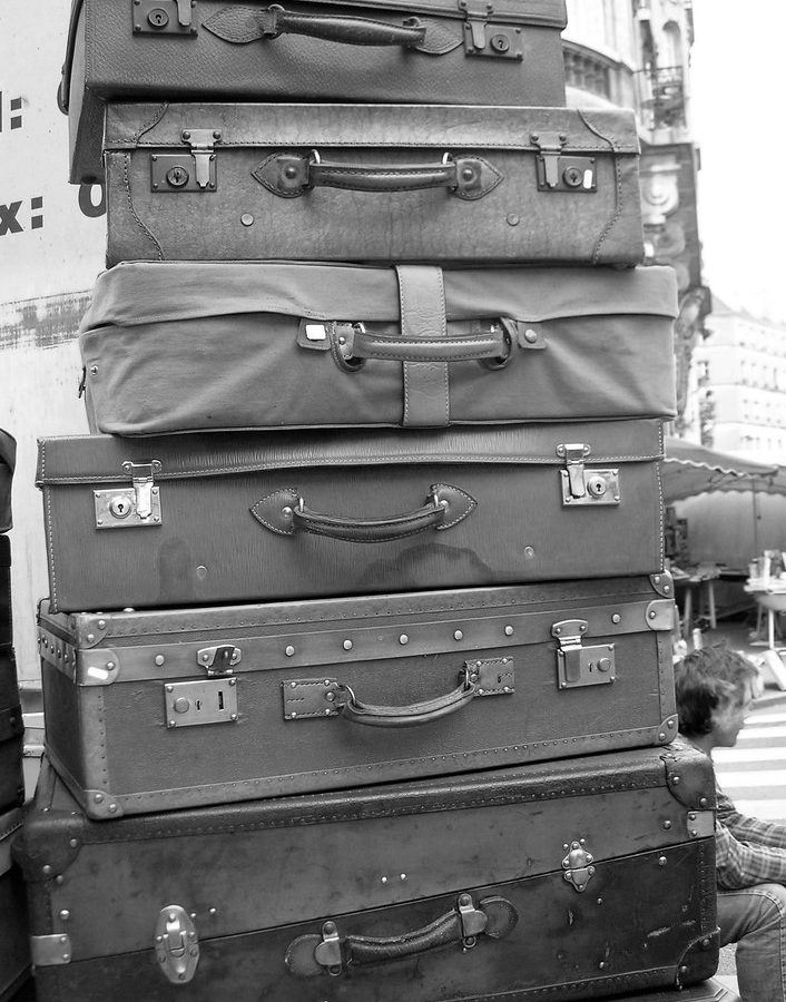 Stacked vintage suitcases — flying with rolling tobacco and RYO gear