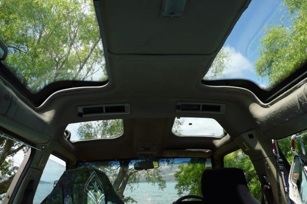 Open car sunroof letting in fresh air — how to get rid of cigarette smell