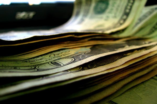 Stack of dollar bills — why cigarettes are so expensive