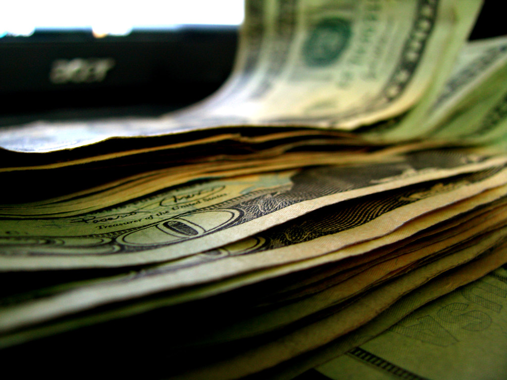 Stack of dollar bills — why cigarettes are so expensive