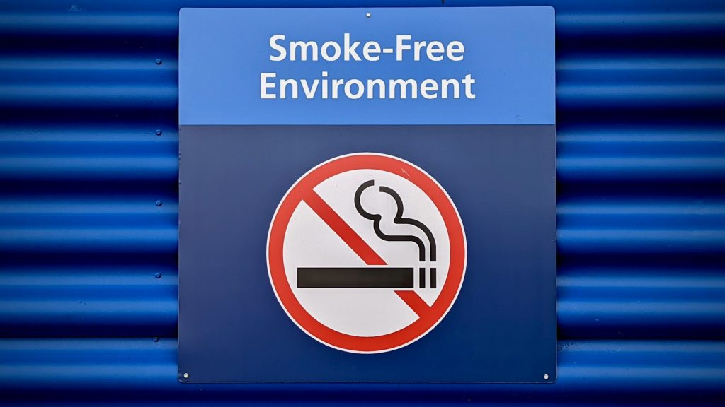A smoke-free environment sign with a no-smoking symbol