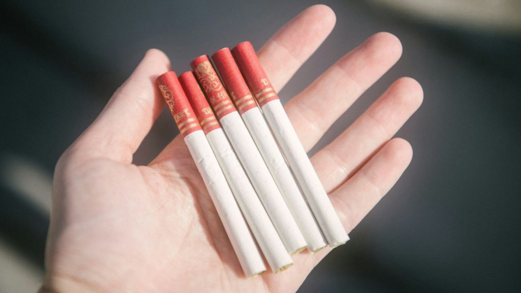 Filtered cigarettes held in an open hand