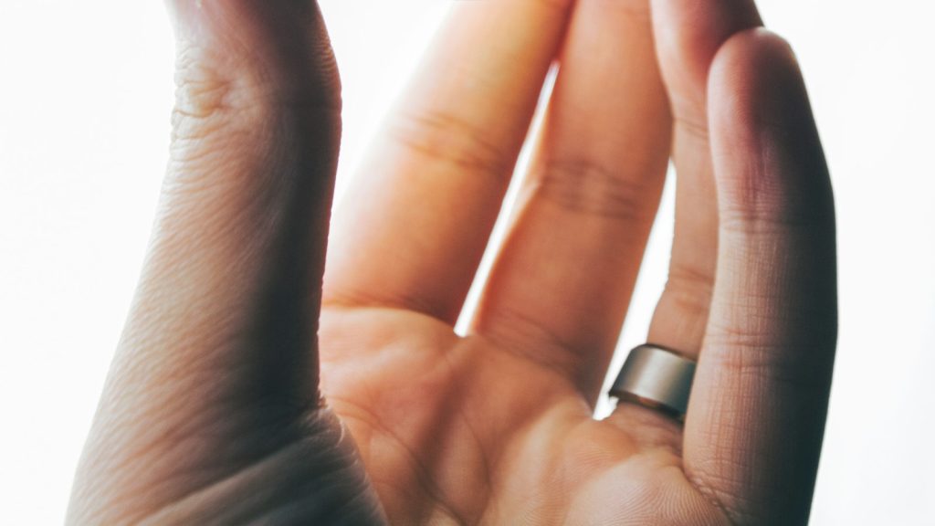 A hand holding a dental model of teeth